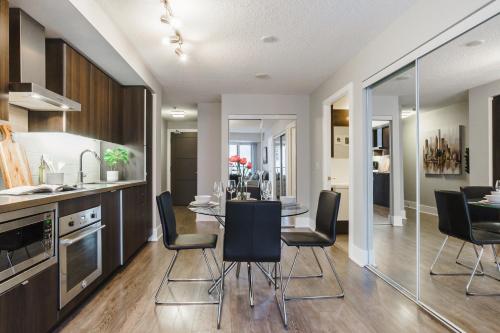 a kitchen and dining room with a table and chairs at Jarvis Inn in Toronto