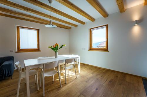 a dining room with a white table and chairs at Casa Corradini by Go New Location in Carano