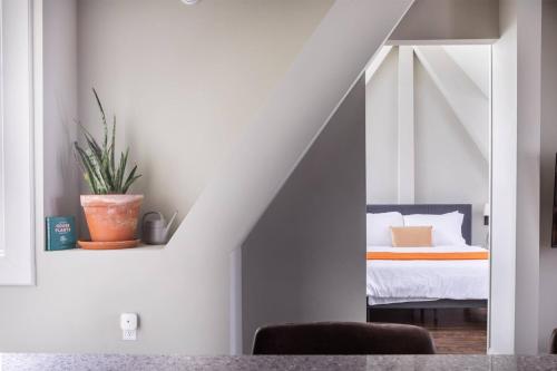 a bedroom with a bed in a white room at Downtown Luxury 1BR Loft in Milwaukee