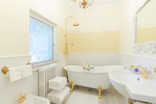 a white bathroom with a tub and a sink at VILLA TOJI luxury private in Bracciano