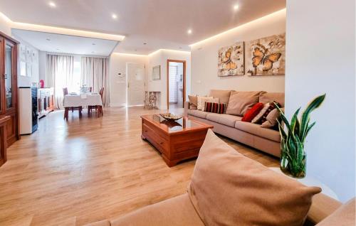 a living room with a couch and a table at 3 Bedroom Amazing Home In Padul in Padul