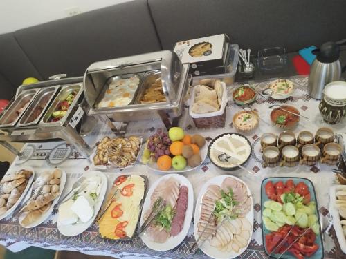 a table topped with lots of different types of food at Blumenhof Bucovina in Voronet
