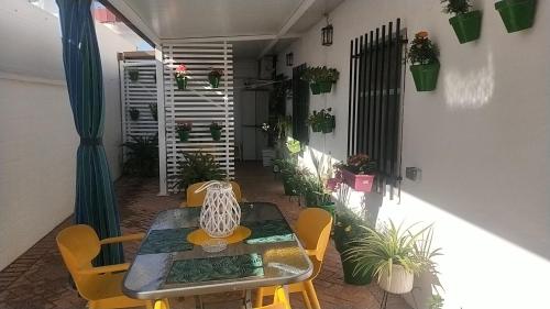 a patio with a table and chairs and plants at 3 bedrooms villa with private pool furnished terrace and wifi at Encinarejo de Cordoba in Encinarejo De Córdoba