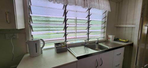 a small kitchen with a sink and a window at Meyenburg Unit 1 in Mount Morgan