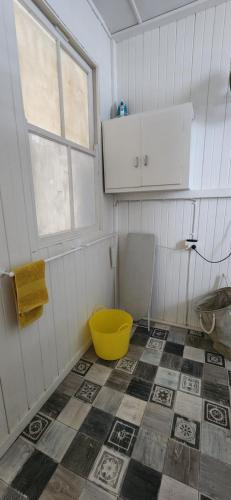 a bathroom with a yellow toilet and a window at Meyenburg Unit 1 in Mount Morgan