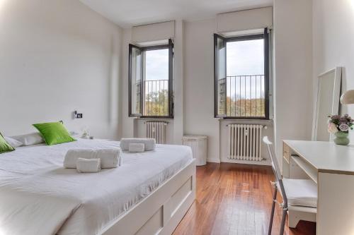 ein weißes Schlafzimmer mit großem Bett und Fenstern in der Unterkunft Balilla30 - Spacious 2 BR APT next to city center in Mailand