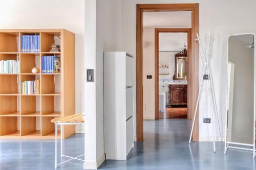 a living room with a white refrigerator and a table at Balilla30 - Spacious 2 BR APT next to city center in Milan