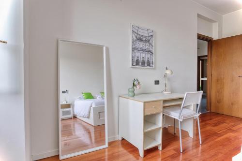 a mirror in a bedroom with a desk and a bed at Balilla30 - Spacious 2 BR APT next to city center in Milan