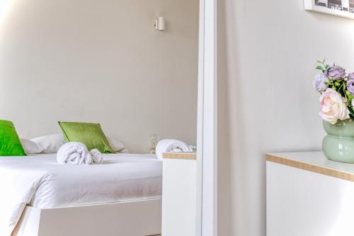 a bedroom with a bed and a vase of flowers at Balilla30 - Spacious 2 BR APT next to city center in Milan