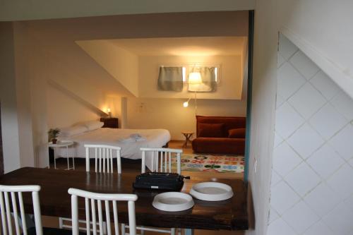 a room with a bed and a table and chairs at La Casa nell'Orto in Fermo