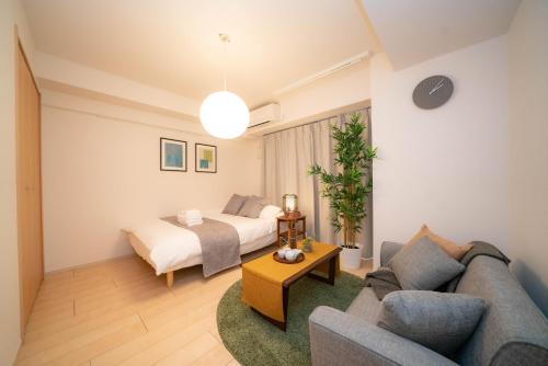 a living room with a bed and a couch at shinjuku1 in Tokyo