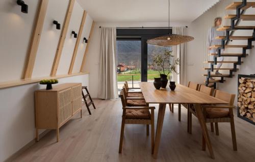 a dining room with a wooden table and chairs at Amazing Home In Rizvanusa in Gospić