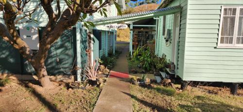 a house with a sidewalk next to a building at Meyenburg Unit 1 in Mount Morgan