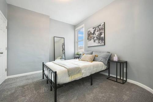 a bedroom with a bed and a window at Luxury Living in Lawrenceville! in Pittsburgh