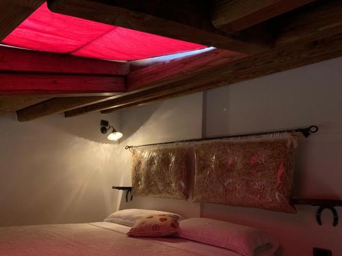 a bedroom with a bed with a red light above it at B&B La Casa della Nonna - L'Antico Fienile in San Martino al Cimino