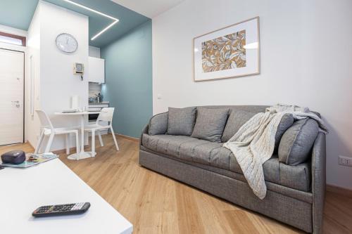 a living room with a couch and a table at Il Chiostro di Santa Caterina in Vimercate