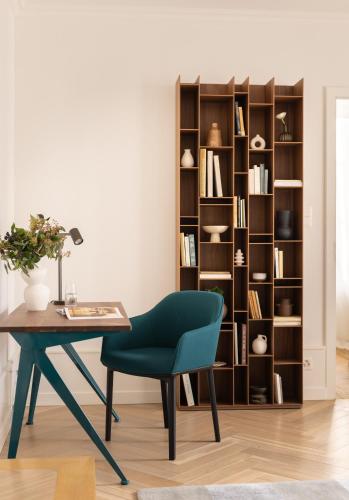 a desk and chair next to a book shelf at The Hamlet - Luxury Serviced Apartments in Geneva