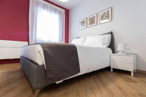 a bedroom with a large bed and a window at Il Chiostro di Santa Caterina in Vimercate