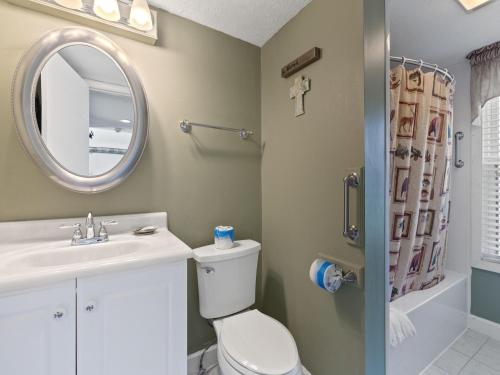 a bathroom with a toilet and a sink and a mirror at Deer Ridge Mountain Resort D204 in Gatlinburg