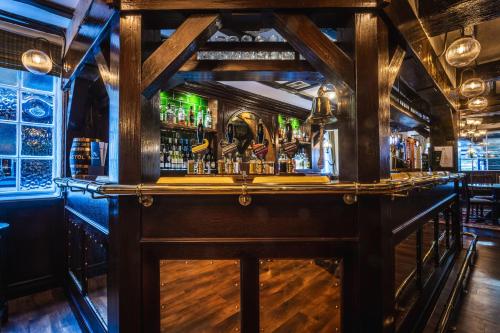 a bar in a pub with a wooden counter top at The Pied Bull in Chester