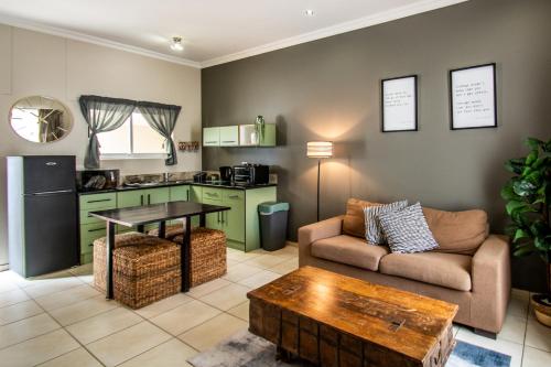 a living room with a couch and a table at Long Beach Selfcatering Namibia in Langstrand