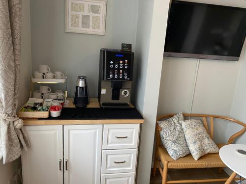 a kitchen with a coffee maker on a counter at Poole Park House in Poole