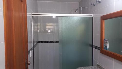 a shower with a glass door in a bathroom at Canzi Cataratas Hotel in Foz do Iguaçu