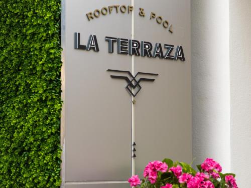 a sign for a la terraza with pink flowers at Kimpton Angler’s Hotel South Beach by IHG in Miami Beach