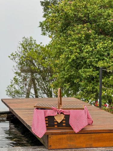 a wooden pier with a box with a heart on it at Vovô Emílio Chalés in Nova Petrópolis