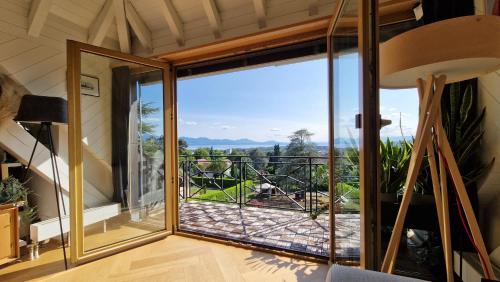 a room with a large glass door with a view at Attic Apartement - Penthouse 2 Bedrooms in Crissier