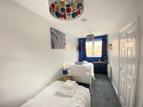 a room with two beds and a sink and a mirror at Arthur's Retreat in Filey