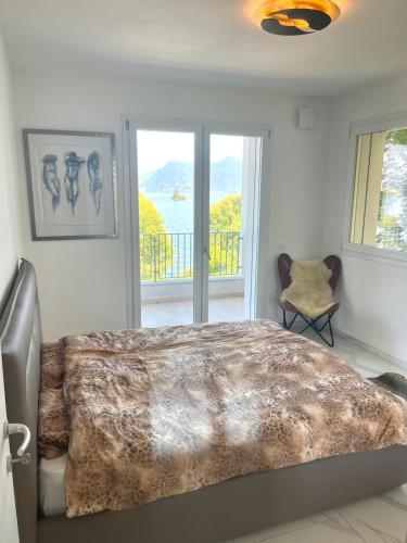 a bedroom with a large bed and a balcony at Isole in Baveno