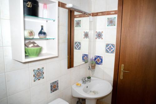 a bathroom with a sink and a toilet and a mirror at Artistic 1 apartment in Afitos