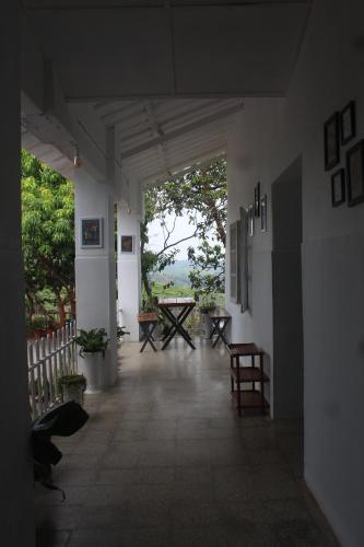 a hallway of a building with a table and chairs at Ward80 Wayanad in Vythiri