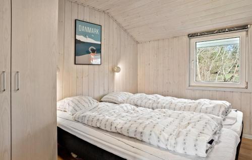 a large bed in a room with a window at Nice Home In Nørre Nebel With Sauna in Nørre Nebel