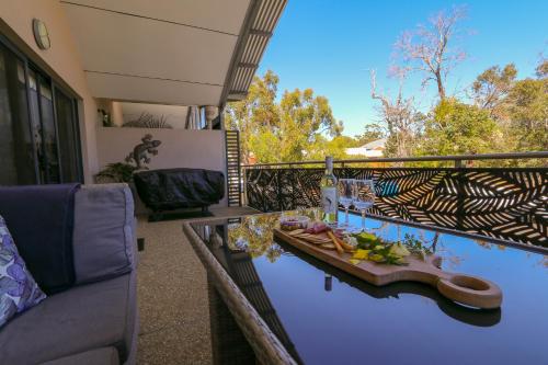 a balcony with a table with food on it at Margaret River Retreat on Fearn in Margaret River Town
