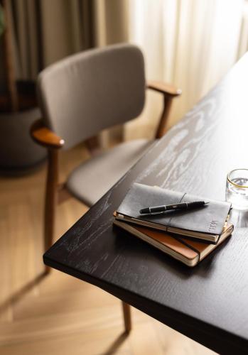 a table with a notebook and a pen on it at The Hamlet - Luxury Serviced Apartments in Geneva