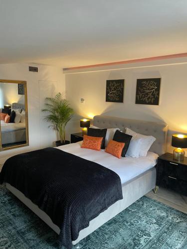 a bedroom with a large bed and a large mirror at La Maison des Rêves - Bran in Bran