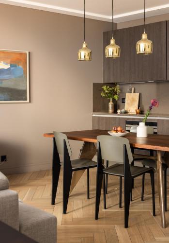 a dining room with a table and chairs at The Hamlet - Luxury Serviced Apartments in Geneva