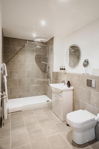 a bathroom with a toilet and a shower and a sink at Udny Arms Hotel in Newburgh