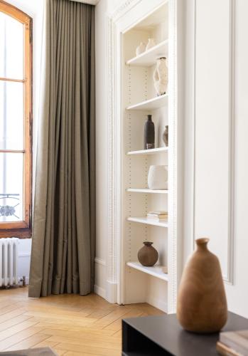 a living room with white shelves and a window at The Hamlet - Luxury Serviced Apartments in Geneva