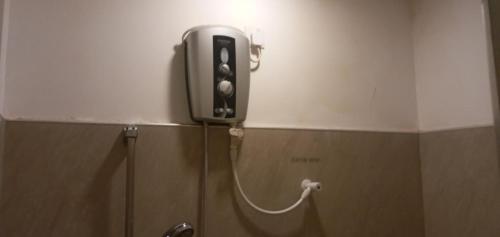 a phone is on the wall of a bathroom at Sudunelum Holiday Resort in Anuradhapura
