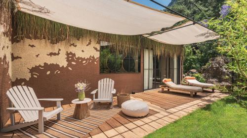 a wooden deck with chairs and an umbrella at Yazz Collective in Fethiye