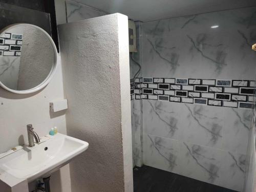 a bathroom with a shower and a sink and a mirror at Stay 7 Jomtien Resort in Jomtien Beach
