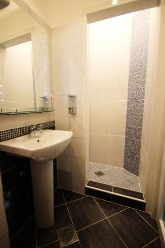 a bathroom with a sink and a shower at Art GuestHouse in Kotor