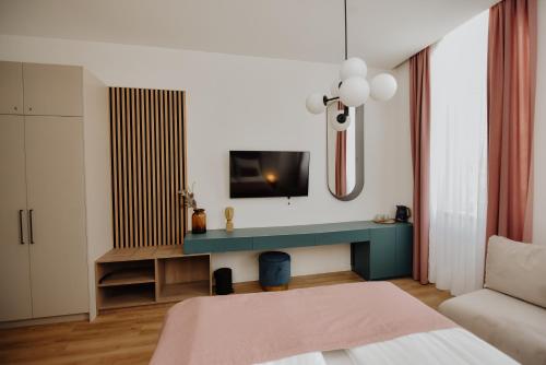 a bedroom with a bed and a tv on a wall at Lux City Apartments & Rooms in Sarajevo
