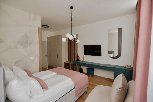 a hotel room with a bed and a tv at Lux City Apartments & Rooms in Sarajevo