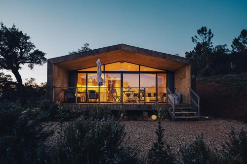 a small house with a large glass wall at MOBA - Monte do Barranquinho in São Luis