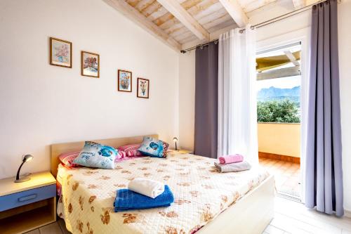 Säng eller sängar i ett rum på Baia delle Mimose - Villetta con aria condizionata e posto auto