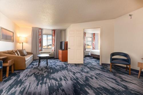 a hotel room with a couch and a bed at Fairfield Inn & Suites by Marriott Spearfish in Spearfish